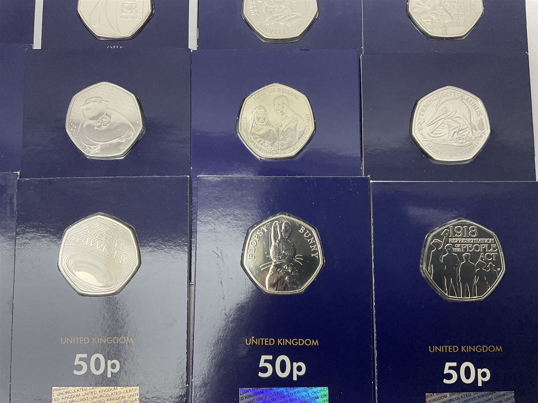 Mostly United Kingdom Queen Elizabeth II commemorative fifty pence coins, including 2019 'Gruffalo', 2020 'Iguanodon', 2022 'The Queen's Jubilee' etc, housed on cards, face value of UK coins approximately 20 GBP