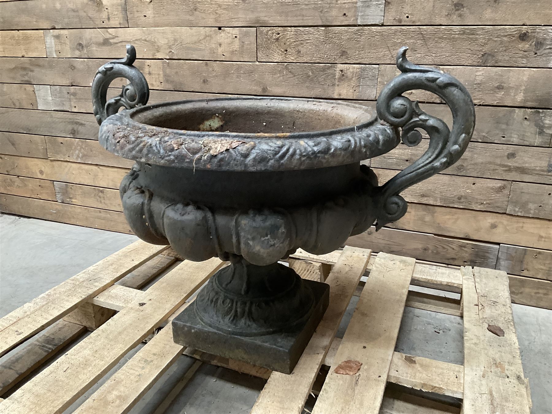 Victorian design ornate cast iron centrepiece urn, featuring two handles, raised on footed base