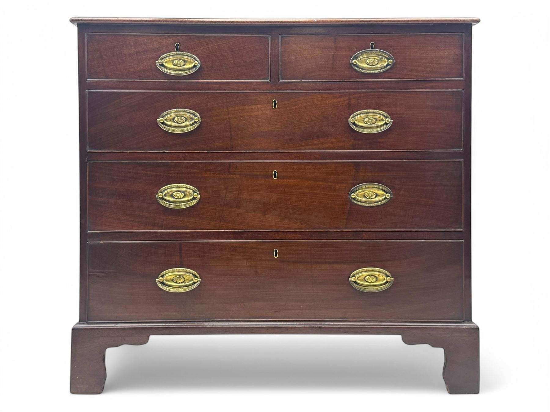 George III mahogany chest, rectangular top with moulded edge over two short and three long graduated cockbeaded drawers, each fitted with brass oval handles, on bracket feet