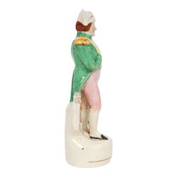 Rare mid 19th century Staffordshire pottery figure of Admiral Lord Nelson, modelled standing in uniform with green tunic, beside anchor, H27cm