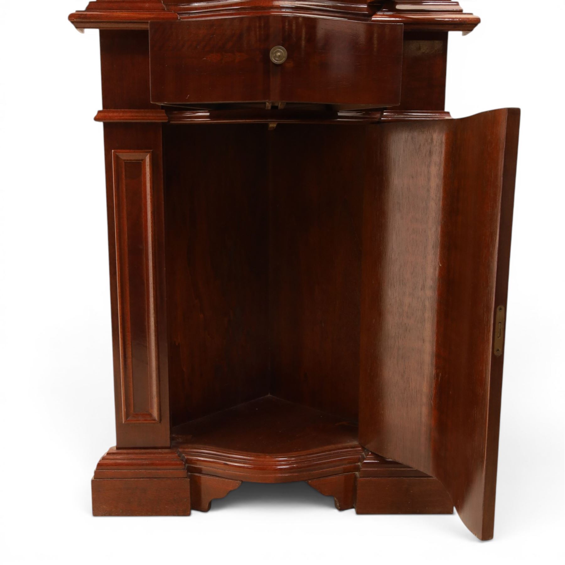 Victorian design mahogany corner cabinet, shaped carved cresting above bowed glazed upper door, with panelled side uprights, lower drawer over cupboard door decorated with floral marquetry, on plinth base