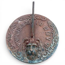 Cast stone garden sundial featuring a cast iron top with Roman numerals and lions head motif