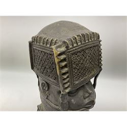 20th century Benin bronze head of an Oba, donning headdress and neck rings with wide open eyes, raised upon a tapering square base, the sides with relief cast knot decoration, H39cm