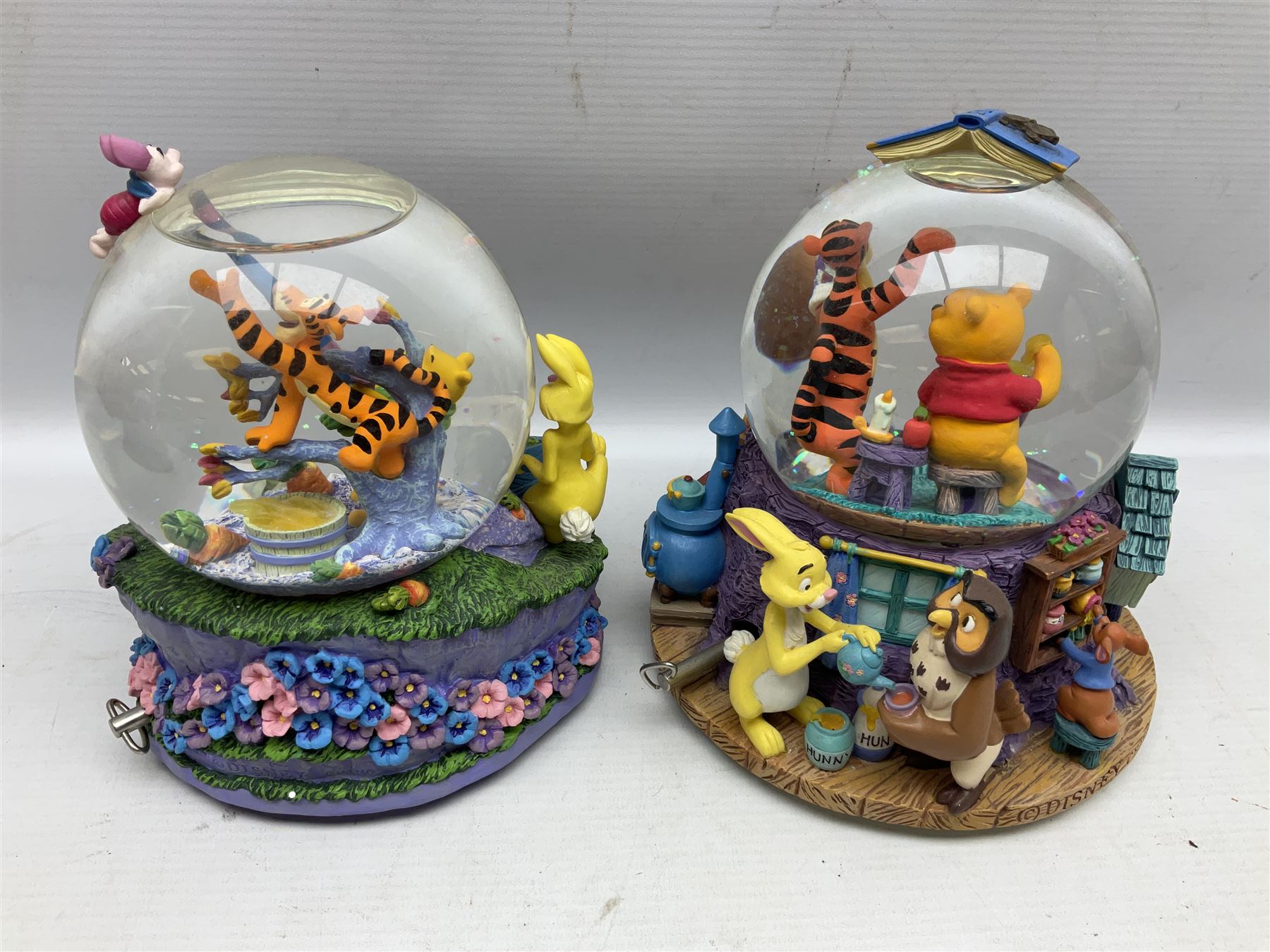 Five Disney Winnie The Pooh snow globes, to include Pooh and Piglet Sailing, Pooh's Grand Adventure and Blustery Day, together with The Walt Disney Classic Waterglobe collection globe and group Tigger, Winnie and Piglet figure under dome, all with boxes (7)