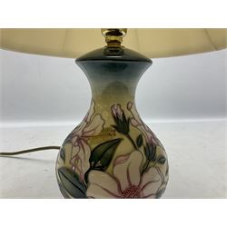 Moorcroft table lamp of baluster form, decorated in the Hibiscus Moon pattern, with Moorcroft cream fabric shade with yellow, green and pink piping, overall H40cm