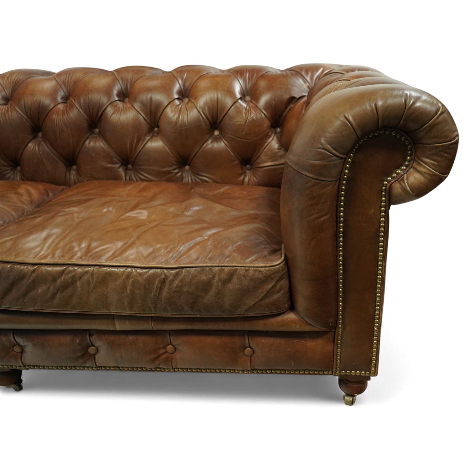 Timothy Oulton for Halo – tan leather three-seater Chesterfield sofa, fully deep-buttoned to the arms, back and seat, with studded front rail, rolled armrests and turned bun supports