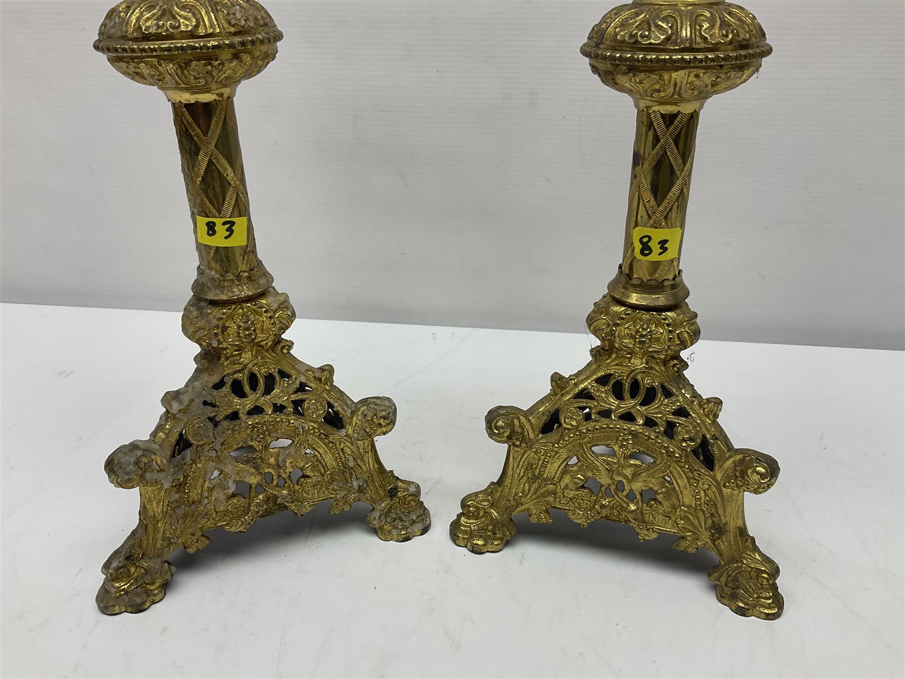 Pair of gilt metal pricket candlesticks, with applied decoration on knopt stems and triform bases, H47cm