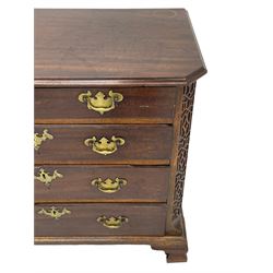 George III Chippendale design mahogany chest, moulded rectangular top with canted corners, wide canted uprights with blind fretwork decoration, two short and three long with moulded fronts, shaped brass handle plates, on ogee bracket feet 