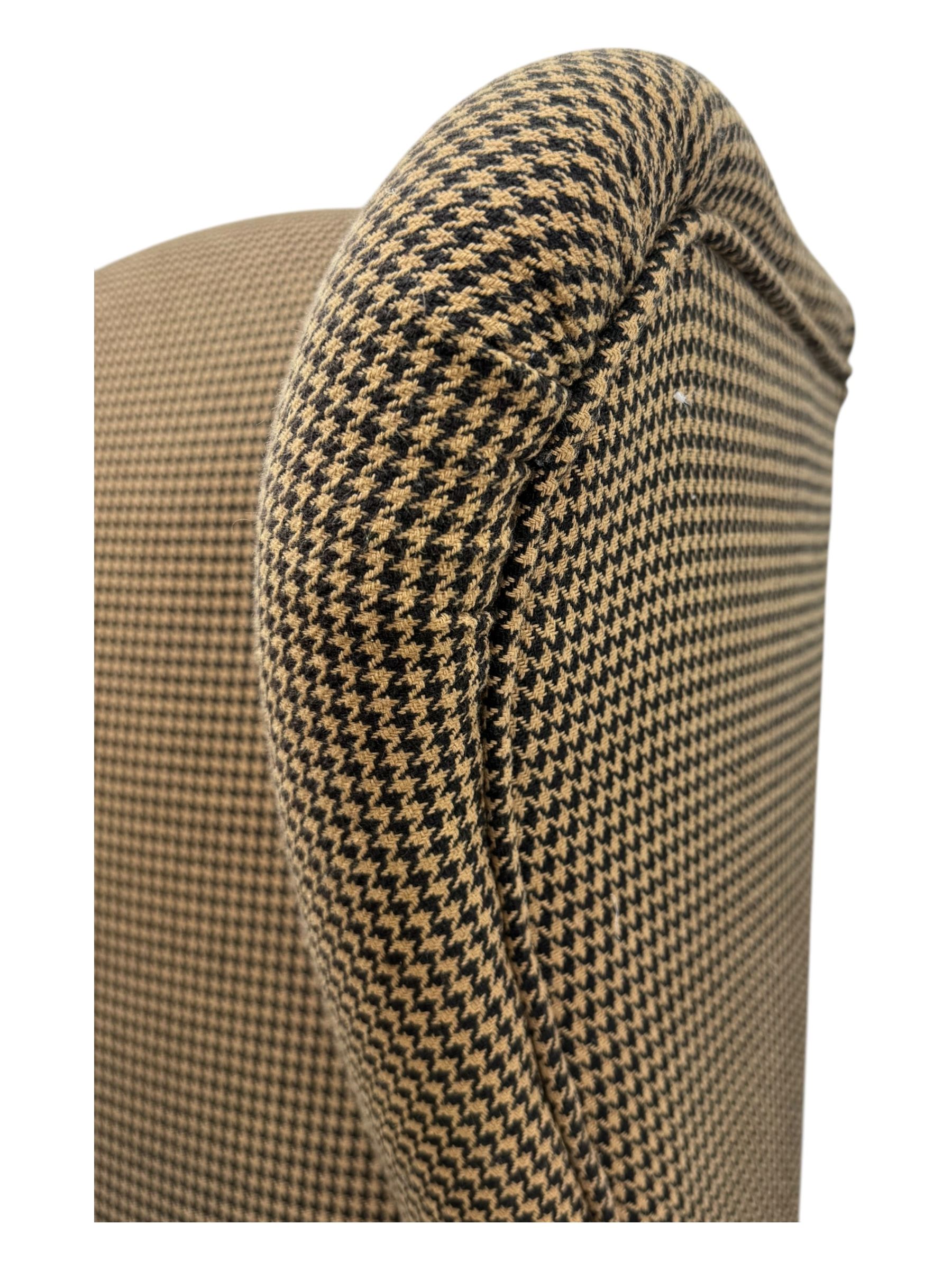 Hardwood-framed wingback armchair, upholstered in dog tooth pattern fabric, on cabriole supports 