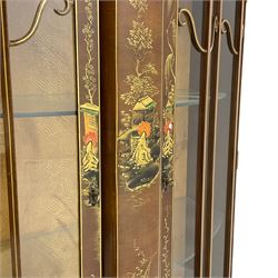 Early 20th century walnut display cabinet with Chinoiserie decoration, the shaped top over two glazed doors enclosing two glass shelves, decorated with raised gilt decoration depicting figures, landscapes and flowers
