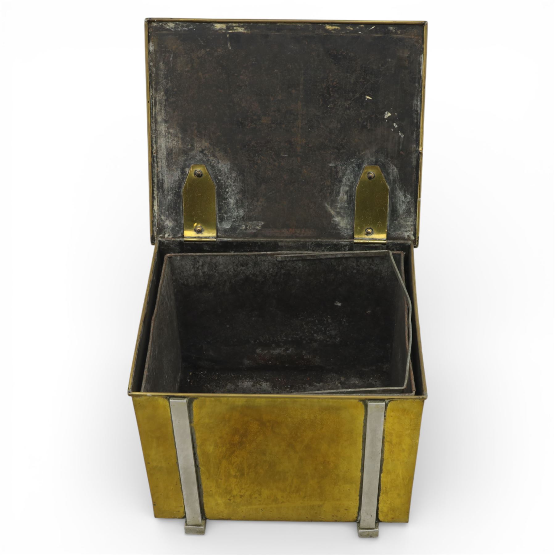 Early 20th century brass coal box, square hinged lid with recessed rectangular handle plates, the front fitted with a swing carrying handle, opening to a removable blackened metal liner, raised on short bracket feet