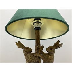 Composite table lamp, modelled as a pair of boxing hares, with a green velvet shade, H45cm