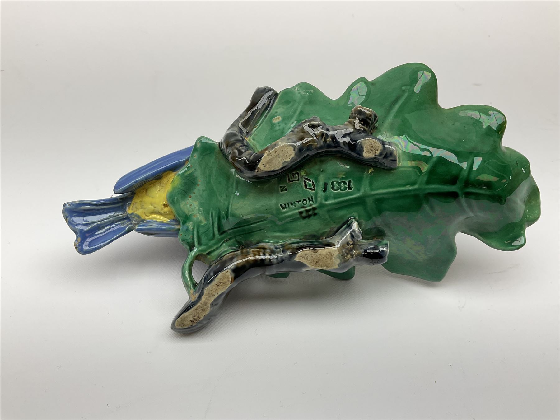 Minton majolica leaf dish, modelled as a Blue Tit perched on a branch with acorns and an oak leaf, date cypher for 1868, impressed marks beneath, L21cm. 