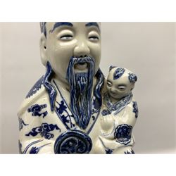 Tall Chinese temple figure of the immortal Fu Xing (Fuxing), the blue and white bearded God modelled in court dress robes cradling a child in one arm and a ruyi-sceptre in the other, with four character seal mark beneath, H52cm