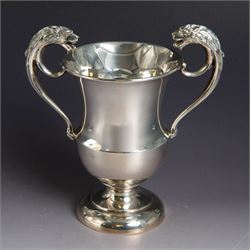 Early 20th century twin handled trophy cup, with lion mask loop handle, upon domed foot, h...