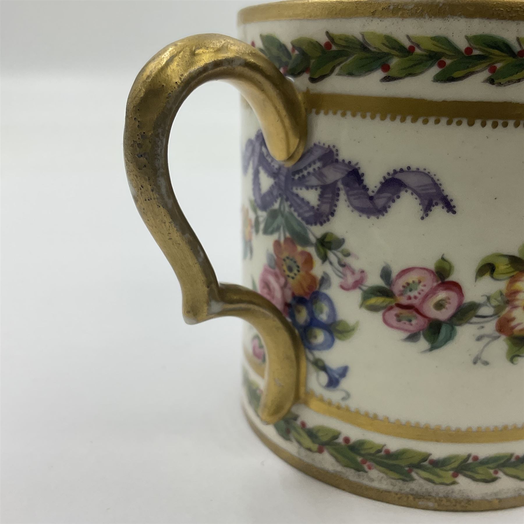 Sèvres soft paste porcelain coffee can and saucer with date code for 1780, painted with pink oval panels bordering bouquets of flowers, united by swags of flowers tied with purple ribbons, within laurel leaf borders, interlaced LL monogram enclosing date letters CC above painters marks for Nicquet, coffee can H7.5cm, saucer D15cm