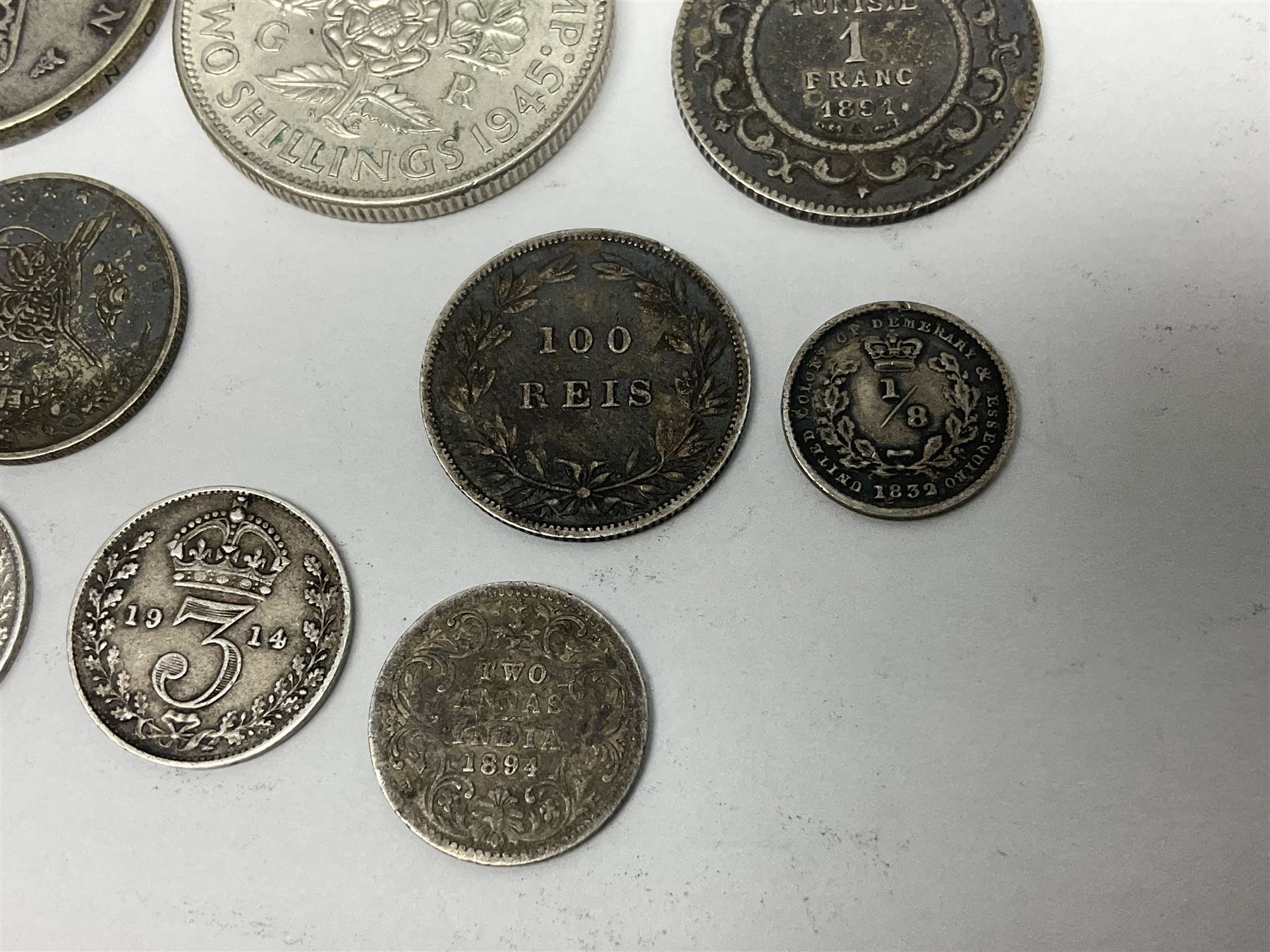 Twelve World coins, including William IIII United Colony of Demerary and Essequibo 1832 one eight guilder, United States of America 1857 quarter dollar, Tunisia 1891 one franc etc 
