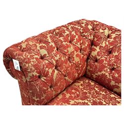 Late 20th century upholstered Chesterfield sofa, in red damask floral fabric, with deep buttoned back and arms, scrolled arms at equal height to back, on turned front supports