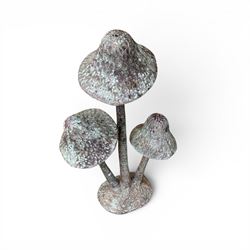 Bronze garden ornament in the form of three mushroom stalks, on naturalistic base
