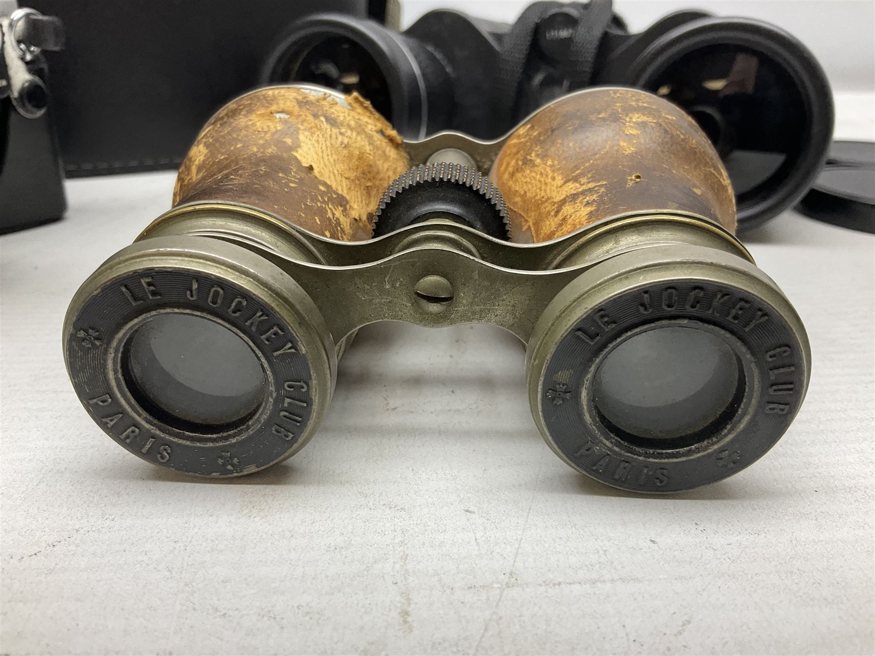 Olympus OM10 35mm camera, cased; pair of USSR 7 x 50 binoculars; cased; and pair of Le Jockey Club Paris binoculars