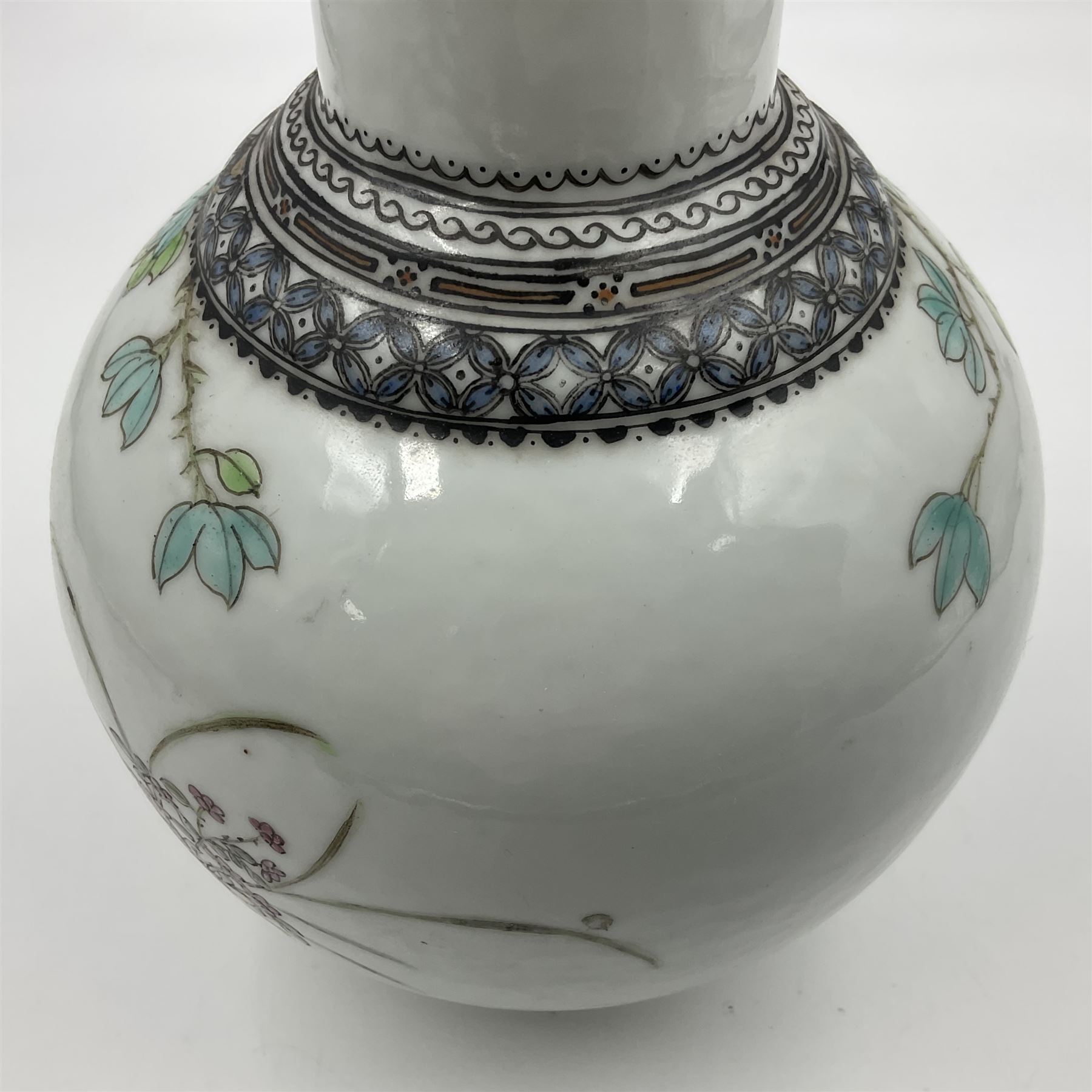 Pair of Chinese Republic porcelain vases, each painted in Famille Rose enamels with pairs of pigeons amidst peony, rock, flowering plants and leafy branches, possibly Qianlong seal beneath, H22cm 