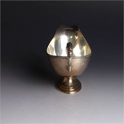 1930s silver sauce boat, of typical form with acanthus capped flying C scroll handle and upon stepped oval foot, hallmarked William Hutton & Sons Ltd, Sheffield 1938, height including handle H10cm