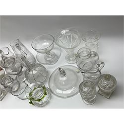 A group of mostly 19th century glassware, to include smoke bell with folded rim, cut glass vase, sugar bowl with part slice cut bowl and knopped stem, pedestal bowl with etched border to rim, documentary marriage jug engraved with date 1899, two cut glass sweet meat jar and covers, vase of squat waisted form with green trailed decoration, etc. 