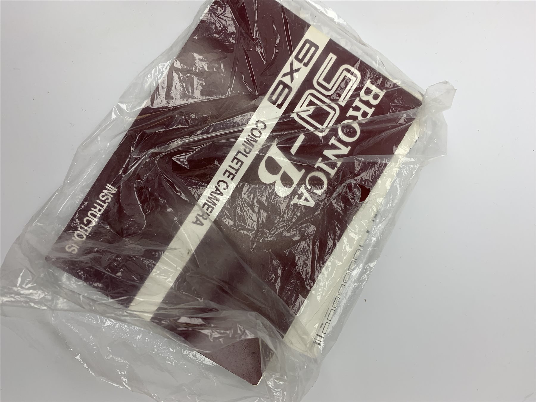 'Zenza Bronica SQ-B' camera fitted with 'Zenza Bronica Zenzanon-PS 1:28 f=80mm' lens, 'Zenza Bronica Zenzanon-PS 1:4 f=150mm' lens and 'Zenza Bronica Zenzanon-S 1:35 f=50mm' lens, with an instruction booklet