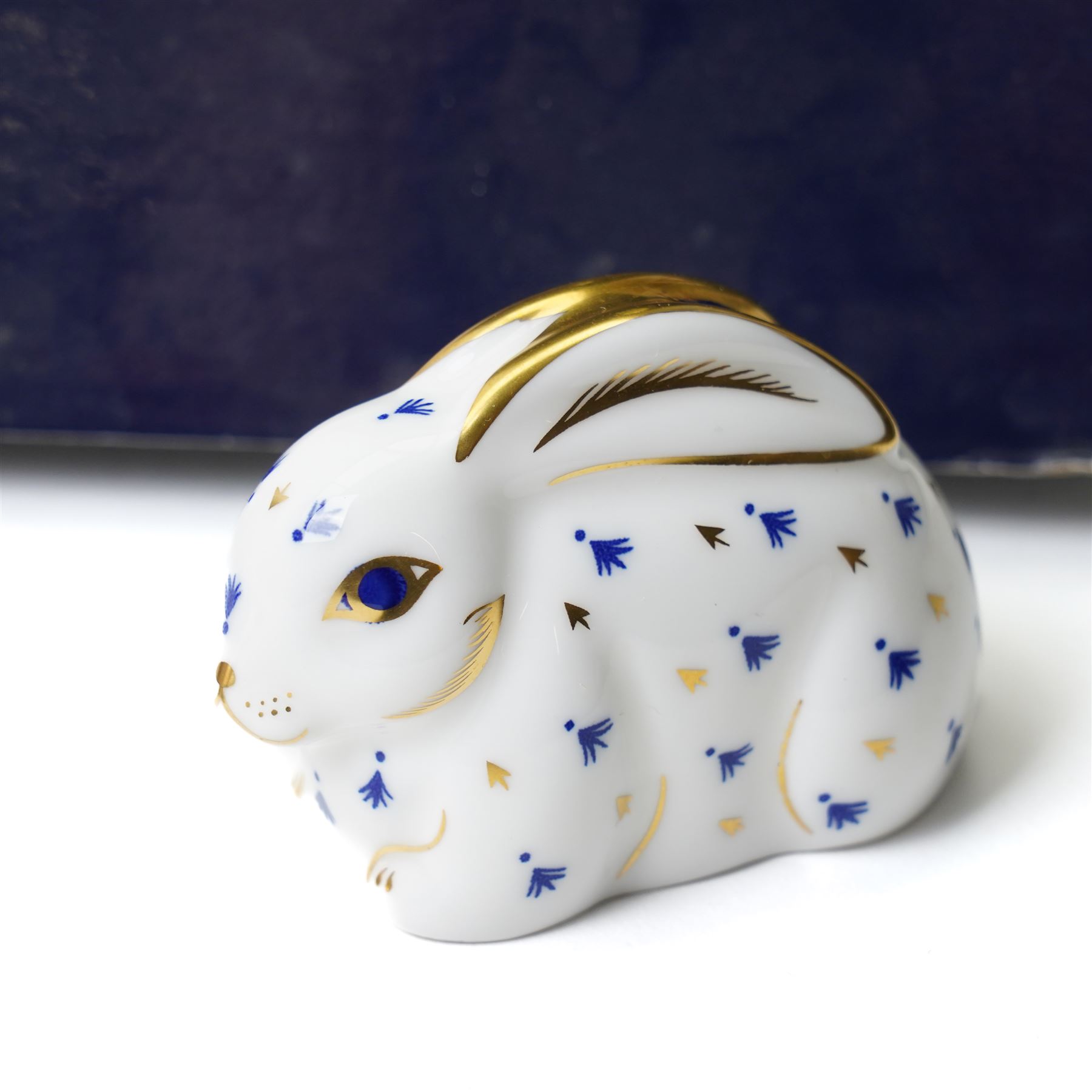 Six Royal Crown Derby paperweights comprising 'Hawthorne' hedgehog with gold stopper, baby rabbit with gold stopper, 'Molly' dog guild exclusive with gold stopper, farmyard hen with gold stopper, woodland squirrel with gold stopper, and collectors guild puppy with gold stopper, all boxed (6)
