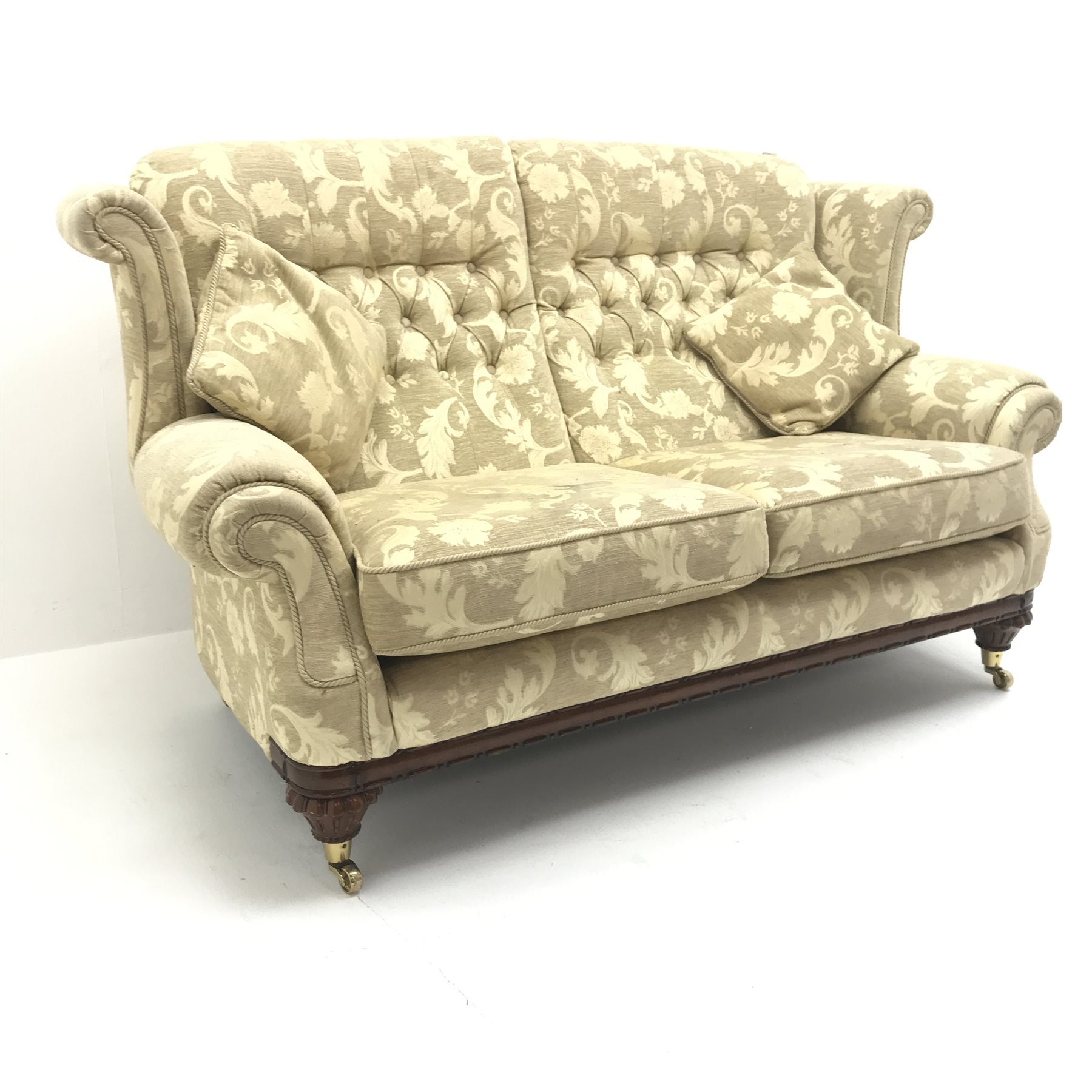 Traditional wing back sofa upholstered in fabric, turned mahogany feet