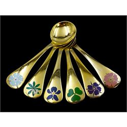 Six Danish silver-gilt year spoons by Georg Jensen, each decorated with different floral motif including violet and shamrock, dated between 1974 and 1981, each impressed on underside RA AB, Sterling Denmark, and marked for Georg Jensen