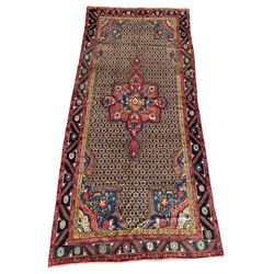 Persian Hamadan rug, the rosette pole medallion on a pale field decorated with stylised motifs, the blue band border decorated with stylised flower heads