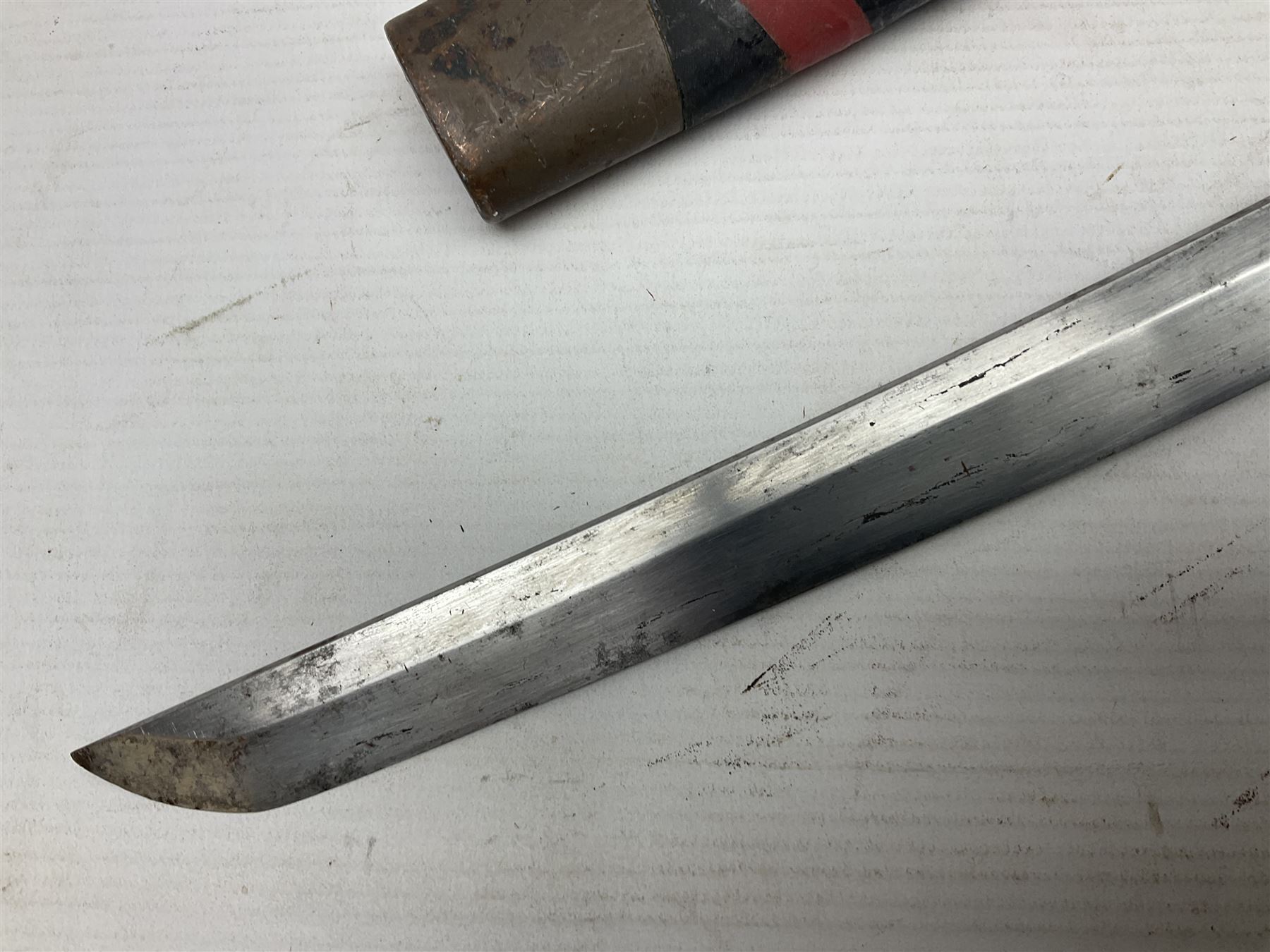 Good quality Japanese sword blade with later WWII fittings and scabbard  - 67.5cm slightly curving blade with unmarked tang, plain iron tsuba and lacquered grip with copper mounts; in lacquered wooden scabbard with tape bound tip L94cm overall
