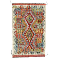 Afghan Chobi Kilim ivory ground rug, central geometric design consisting of stacked lozenge medallions in shades of red, green, and blue, flanked by multicoloured triangular motifs, guarded by zigzag patterns in contrasting tones