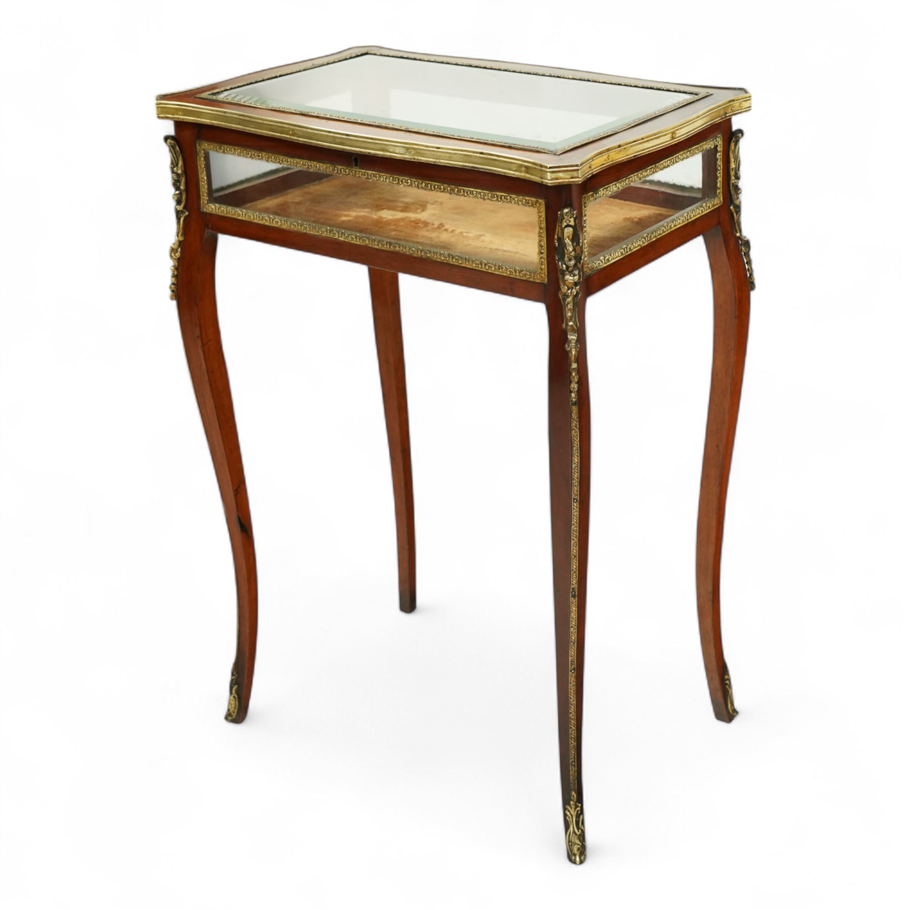 19th century, Louis XV style, bronze mounted bijouterie table, the hinged rectangular bevelled glass top with gilt bronze foliate beading, side glass panels  and plush-lined velvet interior, raised on cabriole legs, with gilt bronze masks and sabots