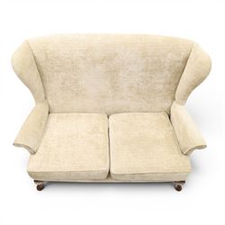 Parker Knoll - 'Hartley' lounge suite, comprising three wingback armchairs and two-seat settee, upholstered in cream fabric, shaped wing backs with scroll-over arms and loose seat cushions, on cabriole supports with pad feet wingbacks and settee

Armchairs: H 96cm, D 83cm, W 75cm