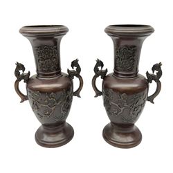Pair of bronze Japanese vases of baluster form cast with birds amongst blossom and hoho bird handles, H28cm