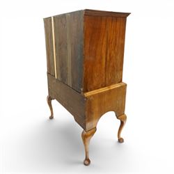 George II figured walnut chest-on-stand, the moulded cavetto top over two short and three long graduating cross-banded drawers, each fitted with pressed brass handle plates, the base fitted with three further drawers over a shaped apron, raised on cabriole supports with pad feet