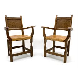 ‘Gnomeman’ set six adzed oak dining chairs, panelled backs, leather upholstered seats with studs, each carved with Gnome signature, four side chairs and two carvers, by Thomas Whittaker of Littlebeck