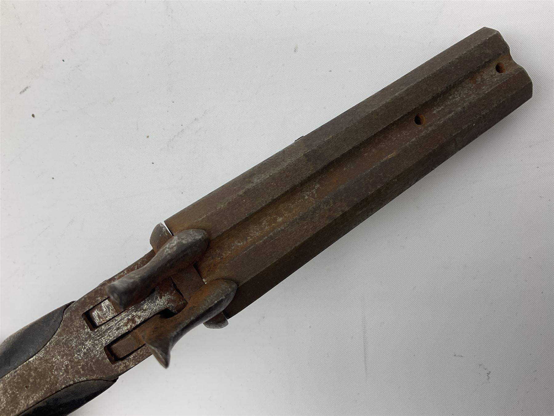 19th century Belgian 9mm side-by-side double barrel pin-fire pocket pistol with 11cm octagonal single block barrel, drop-down triggers and carved walnut stock L22.5cm overall