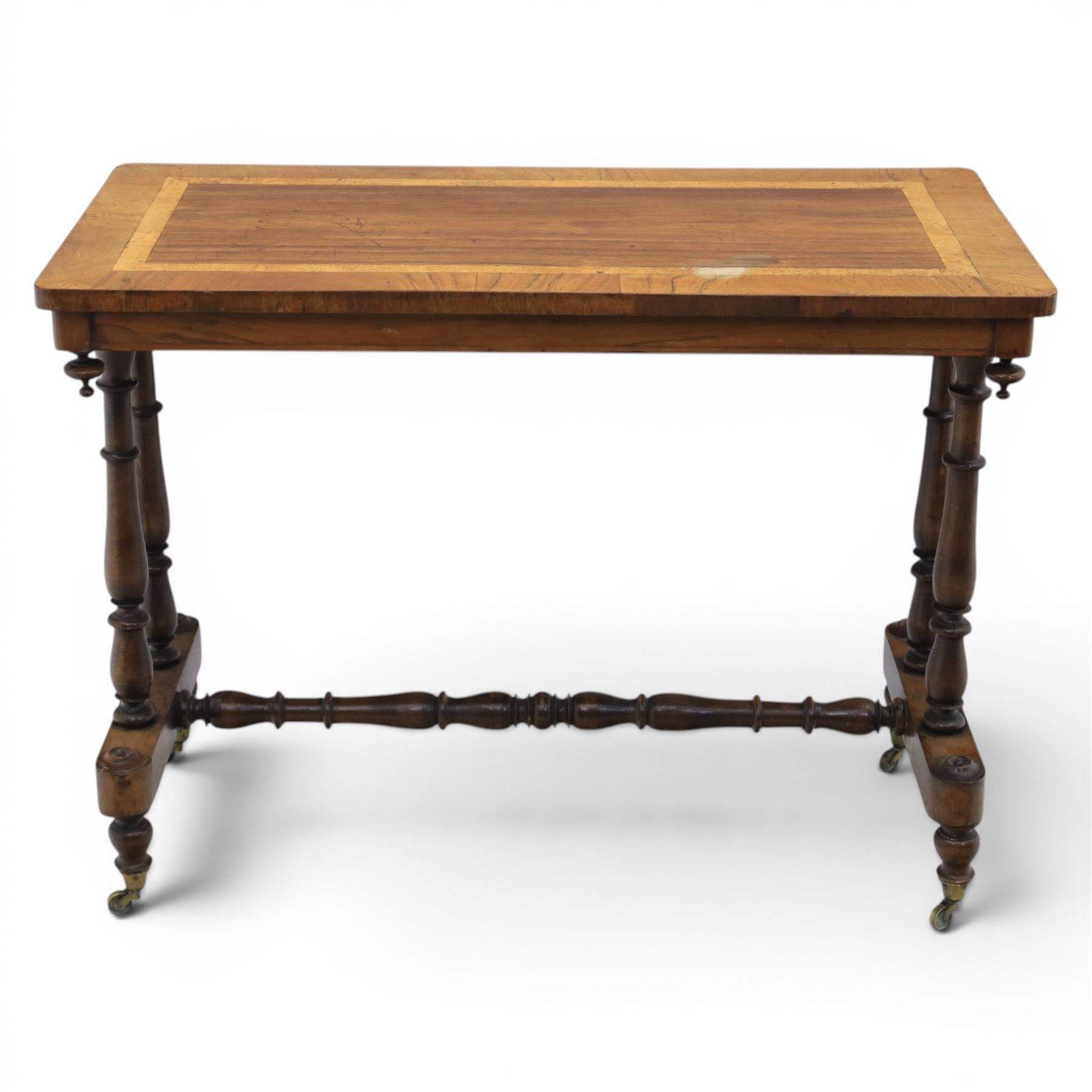 Victorian rosewood and beech stretcher table, rectangular walnut banded top, four turned legs and stretcher, raised on brass castors