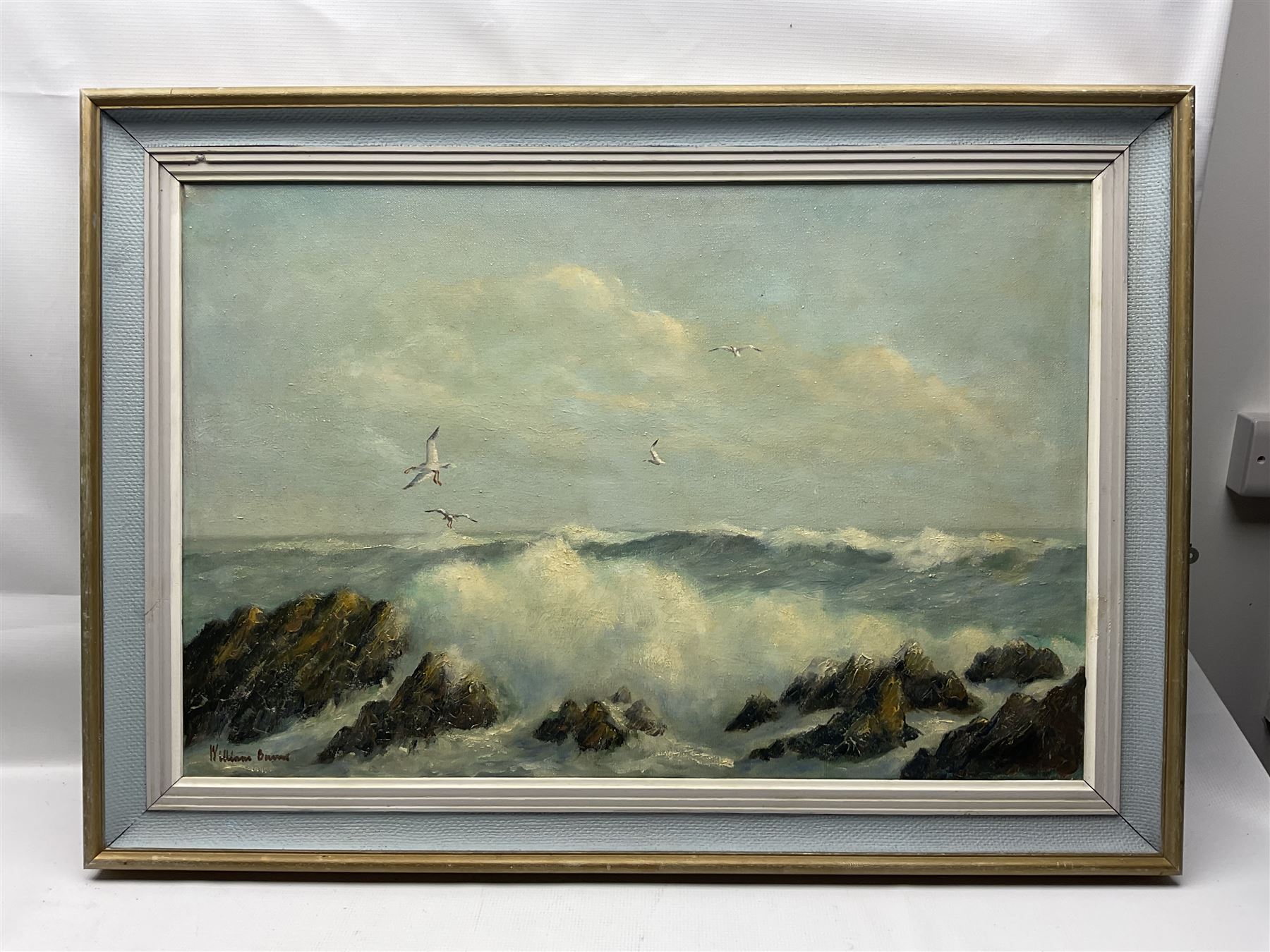 William Burns (Northern British 1923-2010): 'Surf and Rocks - North Devon', oil on board signed, titled verso 50cm x 70cm Provenance: Direct from the family of the artist.
Notes: Born in Sheffield in 1923, William Burns RIBA FSAI FRSA studied at the Sheffield College of Art before the outbreak of the Second World War, during which he helped illustrate the official War Diaries for the North Africa Campaign, and was elected a member of the Armed Forces Art Society. On his return, he studied architecture at Sheffield University and later ran his own successful practice, being a member of the Royal Institute of British Architects. However, painting had always been his self-confessed 'first love', and in the 1970s he gave up architecture to become a full-time artist, having his first one-man exhibition in 1979.