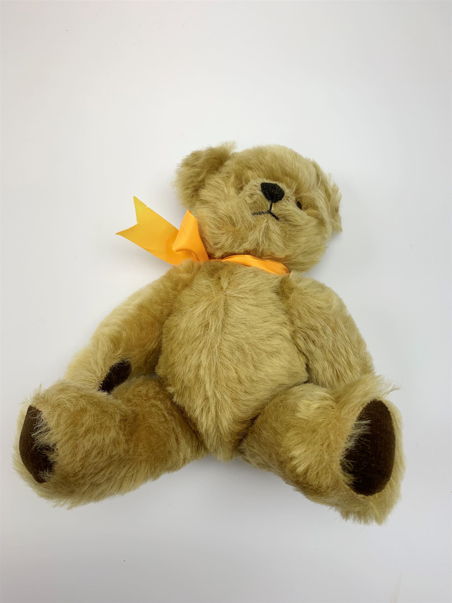 Chad Valley Hygienic Toys teddy bear c1950, kapok filled mohair plush body with original factory given yellow neck ribbon, jointed limbs with velvet paw pads, glass eyes and vertically stitched nose and mouth, blue/white printed label to side seam H12