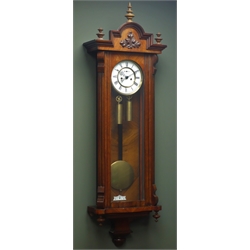  Late 19th century figured walnut Vienna wall clock, stepped arch pediment with turned finials, white enamel dial with subsidiary seconds hand, H122cm  