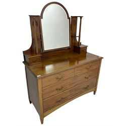 Edwardian mahogany dressing chest, raised arched mirror back with bevelled plate flanked by uprights carved with Art Nouveau tulip motifs over trinket drawers, base fitted with two short over two long drawers
