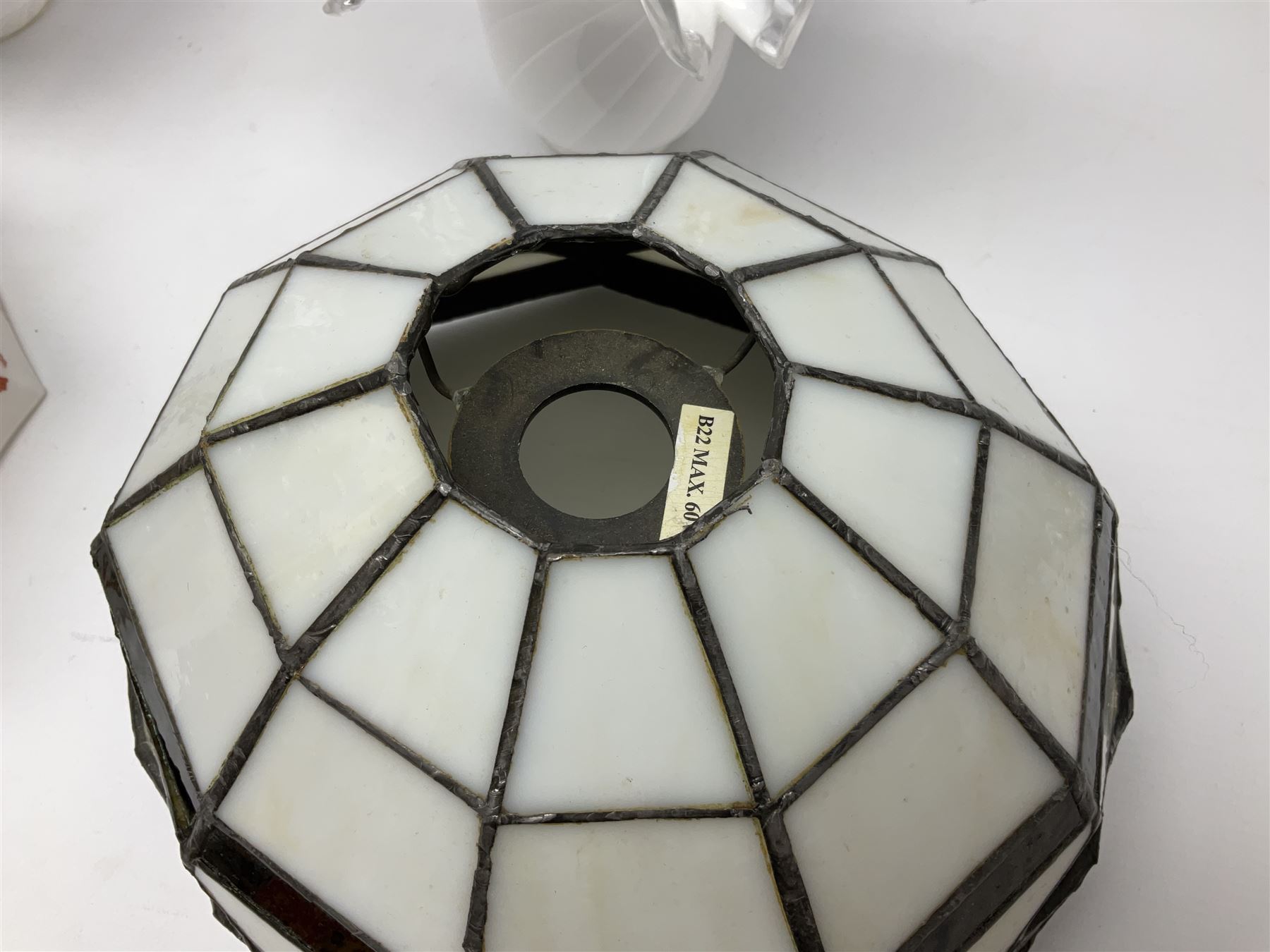 Milk glass lampshade decorated with peacocks, together with a Tiffany style lampshade, a set of five white frilled lamps shades etc 