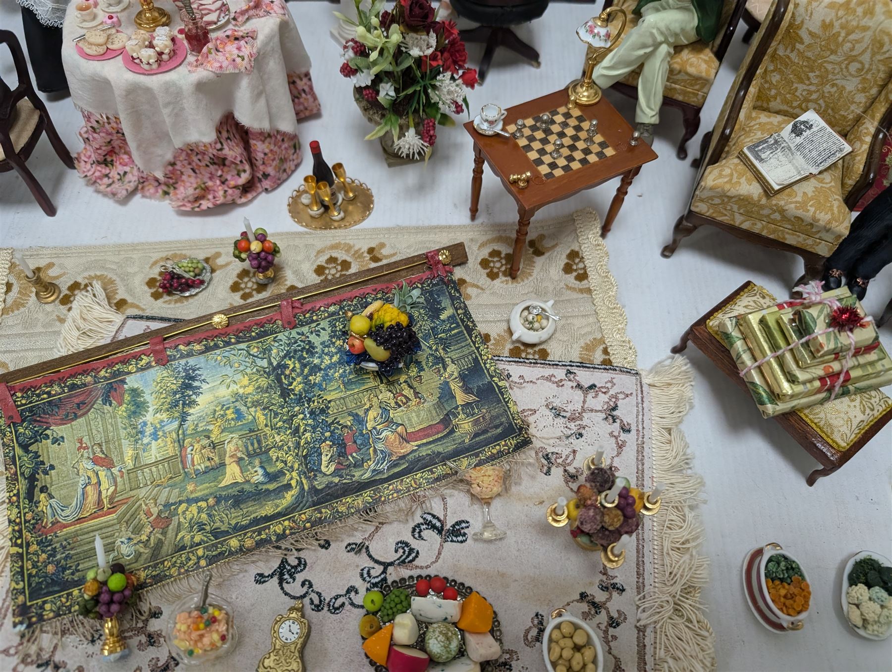 Dolls house living room and dining room furniture, including arm chairs, desk, fireplaces, dressers, tables, eight figures and a large collection of predominantly Christmas themed food, accessories and decorations