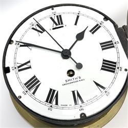 A 20th century Smiths brass cased bulkhead clock with a single train eight-day going barrel movement and balance escapement, white enamel dial with Roman numerals, minute track and five-minute Arabic’s, steel spade hands and centre second hand, dial inscribed “Smiths, Cricklewood N.W, Made in England” brass cast bezel with lock and key, flat glass with silvered sight ring, slow fast balance regulation.
Case diameter 22cm, bezel diameter 19cm.
With key
