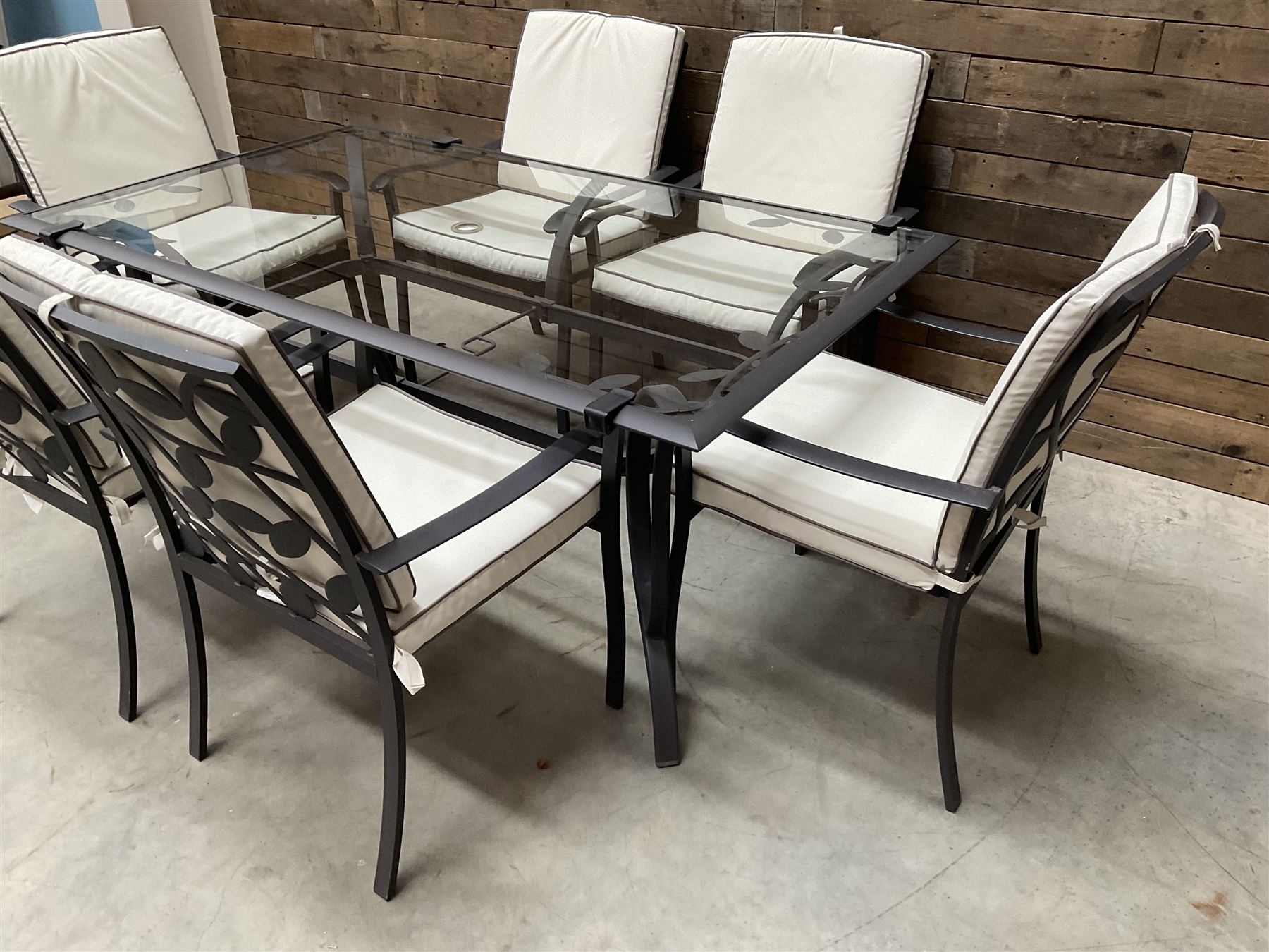 Metal framed garden table with glazed top (W170cm, D102cm, H71cm) and six armchairs with cushions 