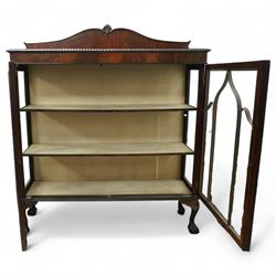 Early 20th century mahogany display cabinet, shaped pediment over a dentil moulded cornice, twin astragal glazed doors enclosing three shelves, raised on cabriole supports with pad feet
